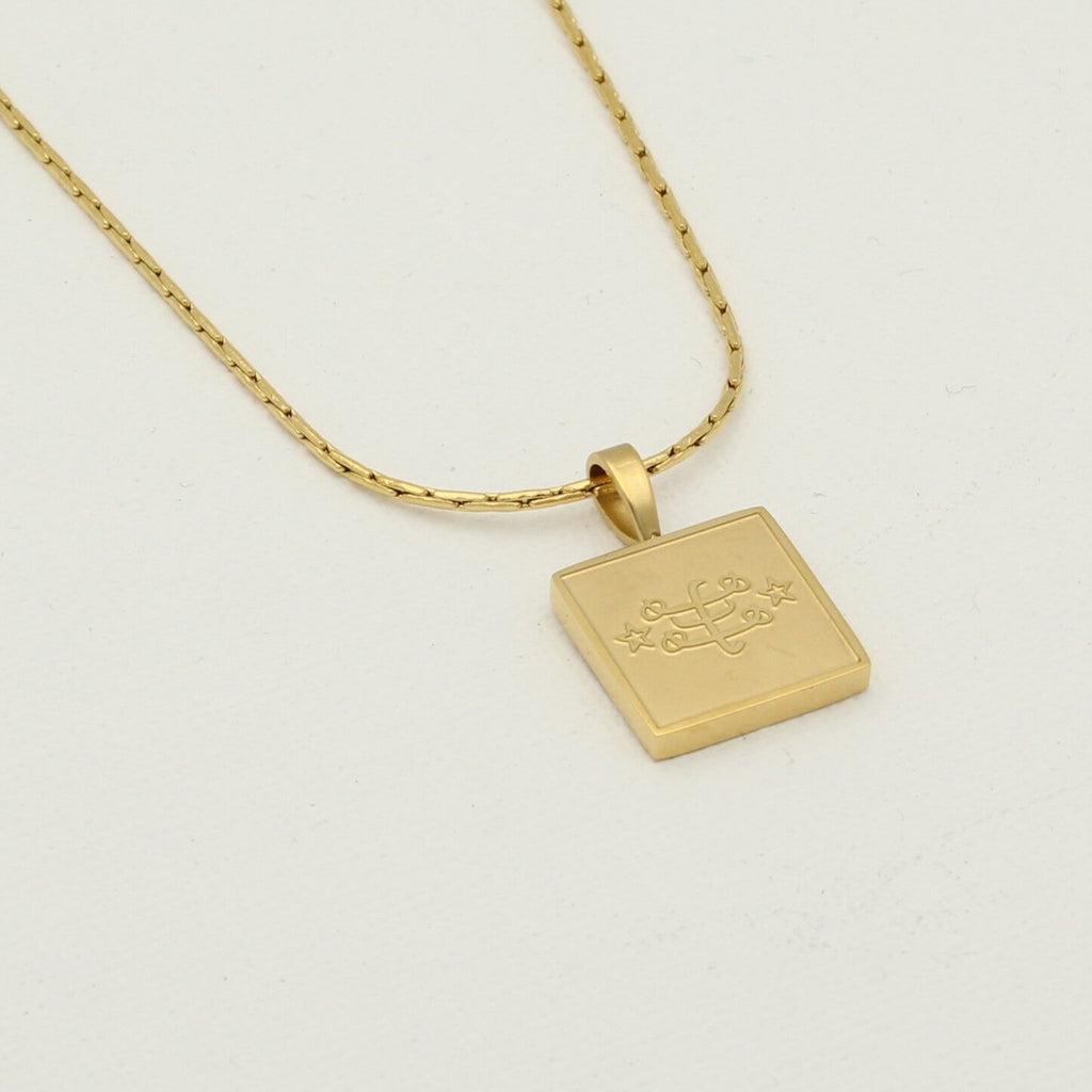 Square stainless steel necklace in gold with engraved Ringstone Symbol pendant by Maconi Jewelry
