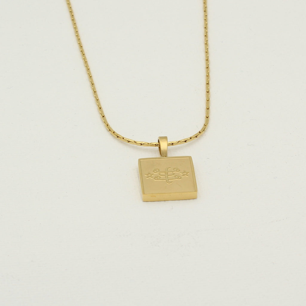 Square stainless steel necklace in gold with engraved Ringstone Symbol by Maconi Jewelry