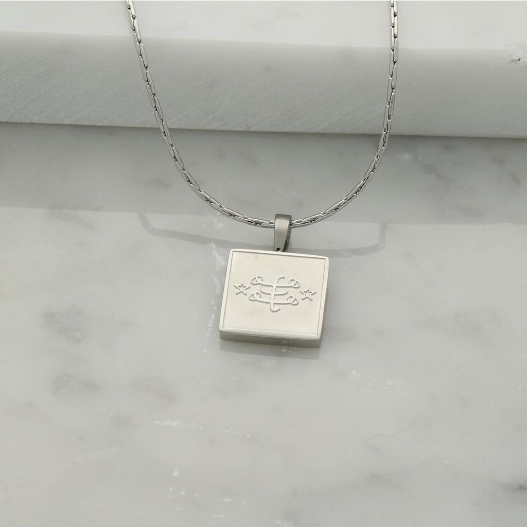 Square stainless steel necklace in silver with engraved Ringstone Symbol by Maconi Jewelry