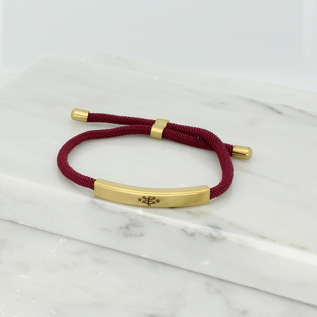 Adjustable gold bracelet with burgundy nylon cord and engraved Ringstone Symbol by Maconi Jewelry