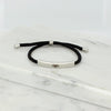 Adjustable silver bracelet with black nylon cord and engraved Ringstone Symbol by Maconi Jewelry