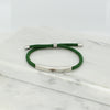 Adjustable silver bracelet with green nylon cord and engraved Ringstone Symbol by Maconi Jewelry