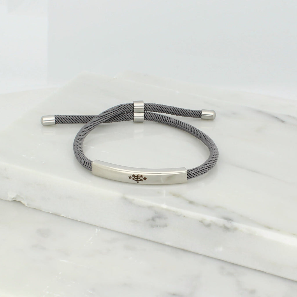 Adjustable silver bracelet with grey nylon cord and engraved Ringstone Symbol by Maconi Jewelry