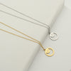 Silver and gold minimal necklaces with engraved 9-pointed star symbol by Maconi Jewelry