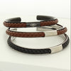 Open bangles with braided leather and engraved Ringstone Symbol by Maconi Jewelry